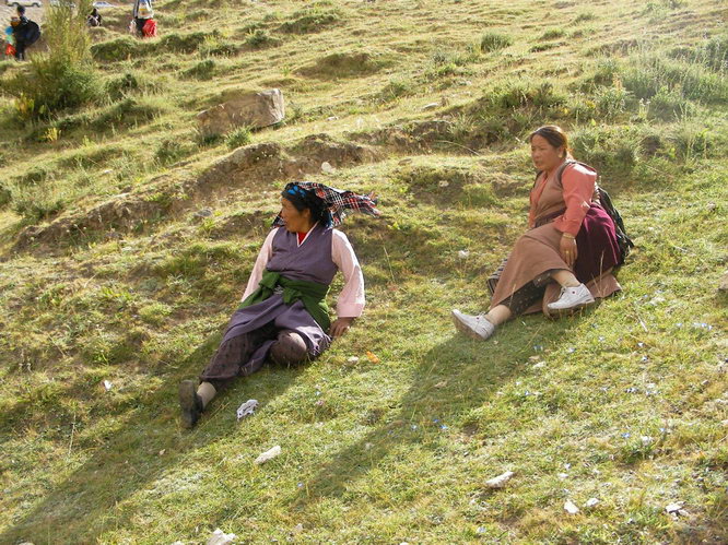 Two womean relaxing at the Drak Yerpa tsechu festival.